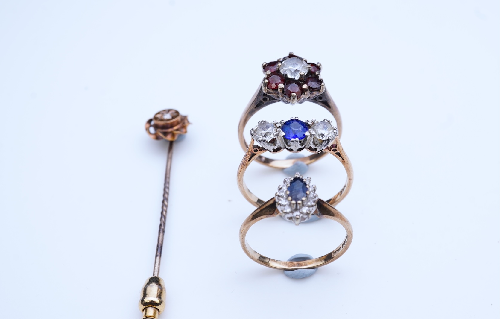 A group of three rings and a tie pin